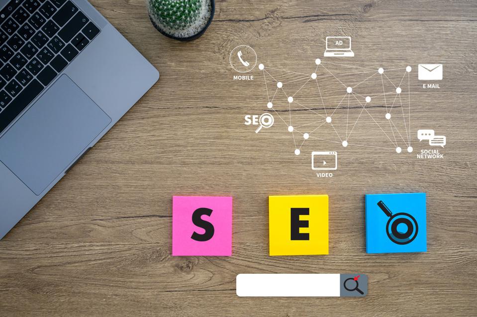 top down image of a laptop on the left and the letters s e o on individual sticket notes